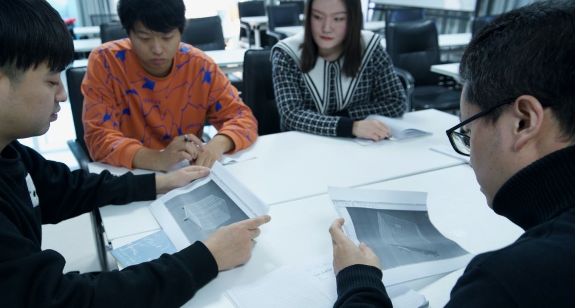 Several workers work together and discuss.