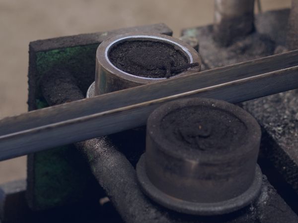 A forming machine is forming sheets into grooves.