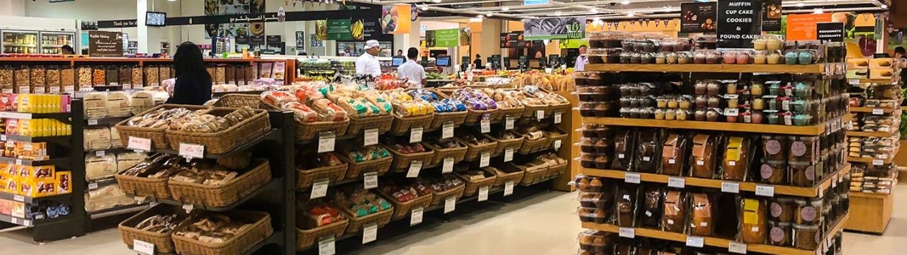 Several shelves with goods in the supermarkets.