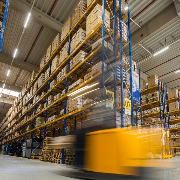 A forklift is working in the warehouse.